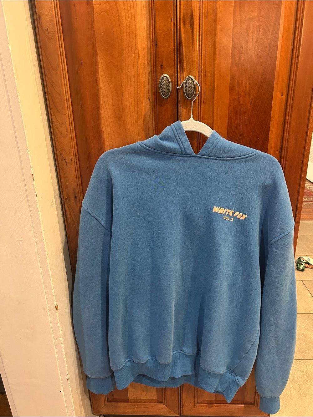 Royal blue White Fox hoodie with raised/puffy peach colored lettering.